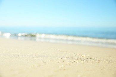 Beautiful sandy beach and sea under blue sky, closeup