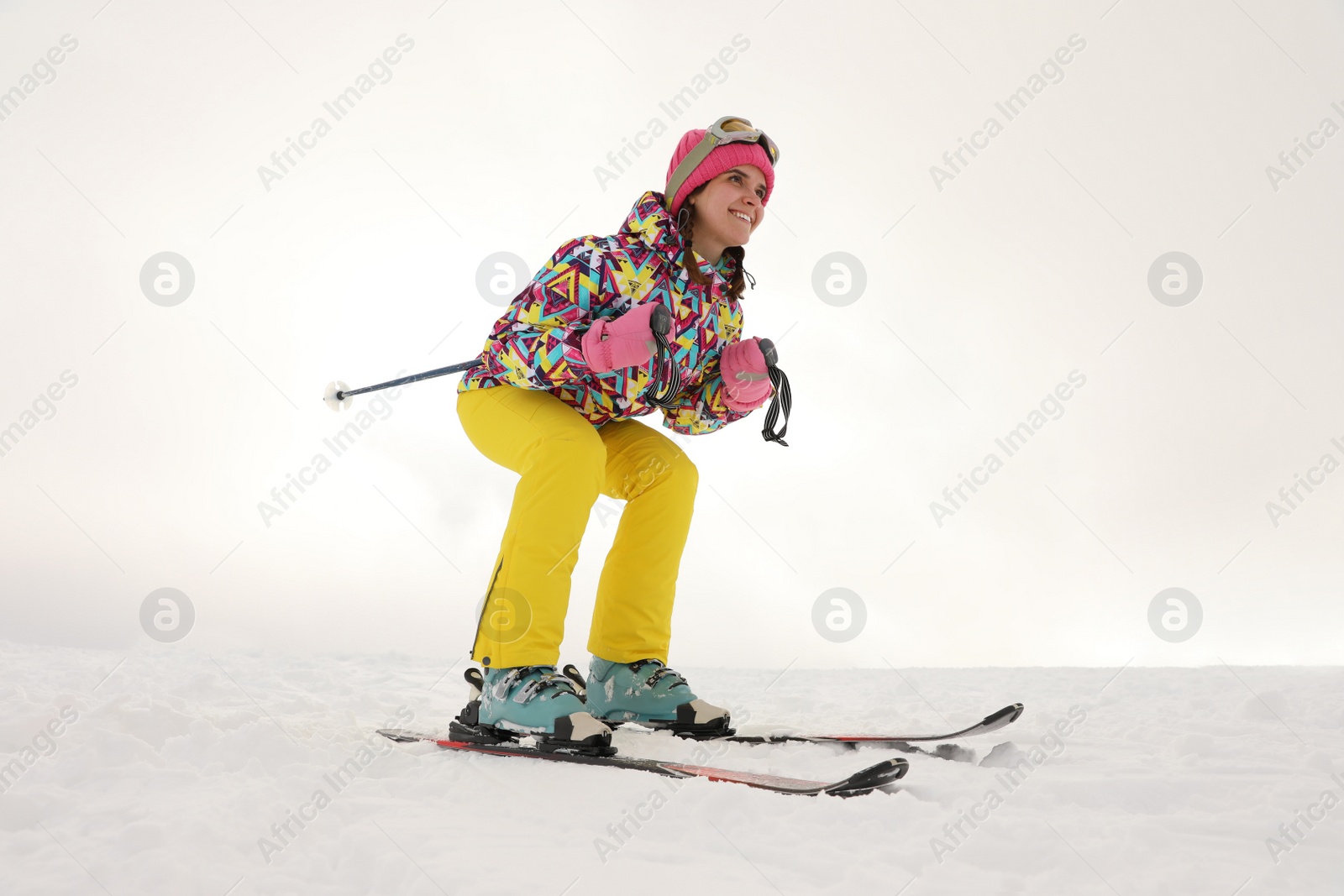 Photo of Young woman skiing on snowy hill. Winter vacation