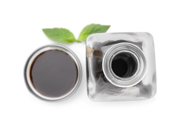 Photo of Organic balsamic vinegar and basil isolated on white, top view