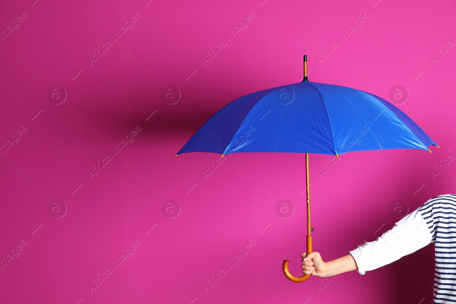 Photo of Woman holding beautiful umbrella on color background with space for design