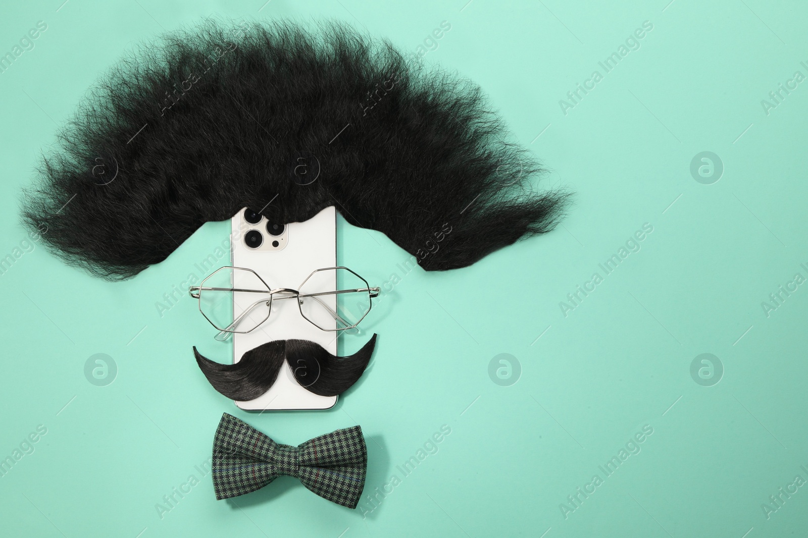 Photo of Flat lay composition with artificial moustache and glasses on turquoise background, space for text