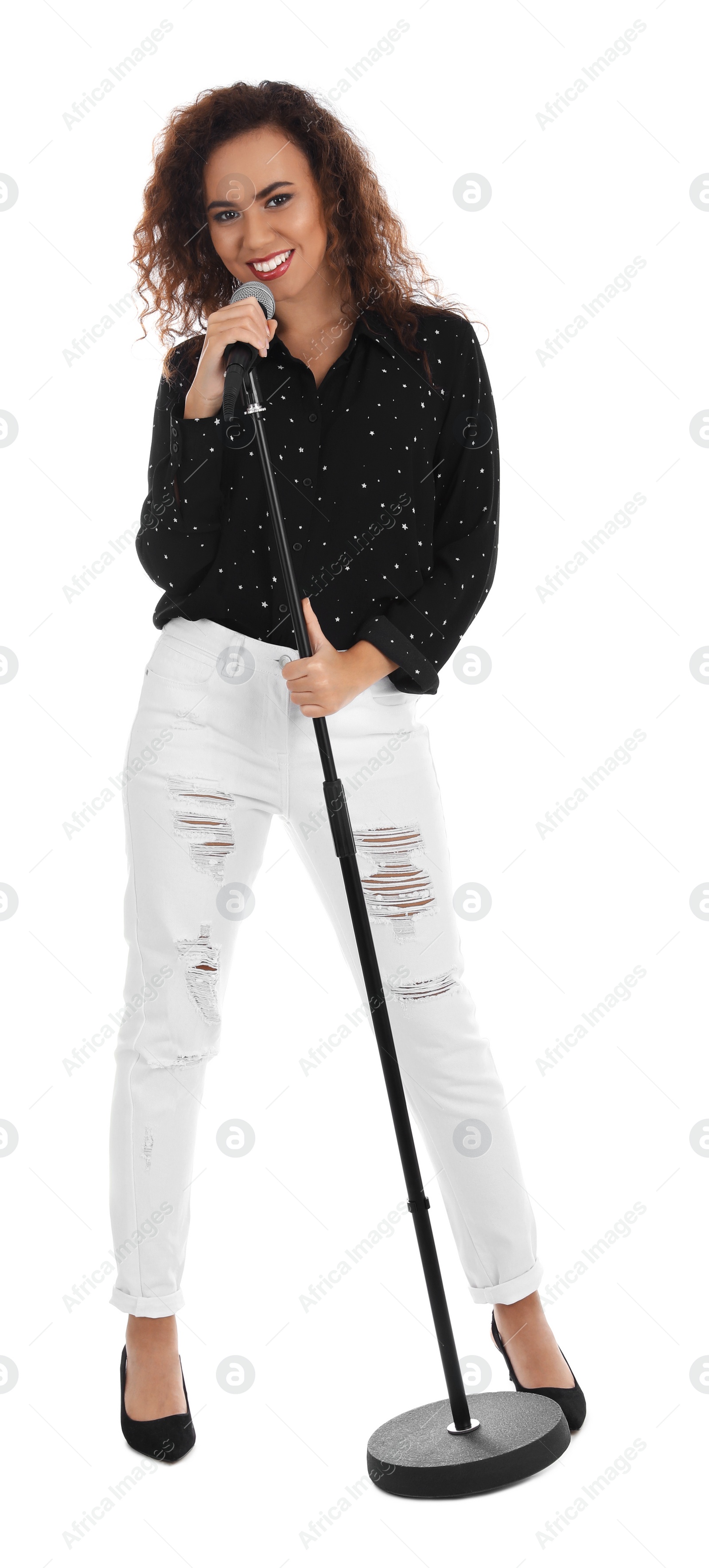 Photo of Curly African-American woman in stylish clothes posing with microphone on white background