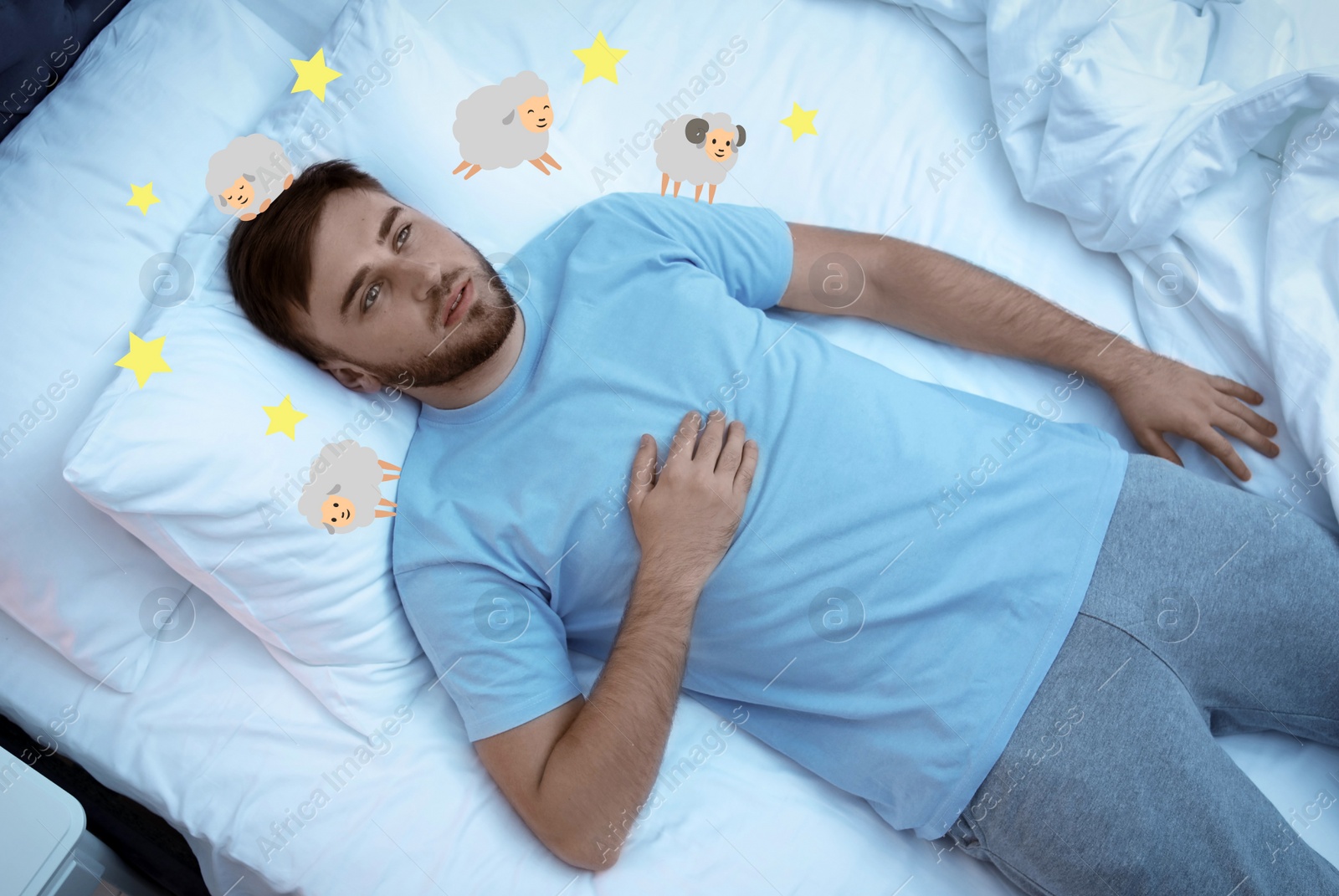 Image of Young man trying to fall asleep counting sheep in bed, above view