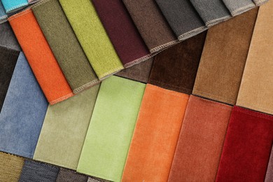 Photo of Fabric samples of different colors as background, top view