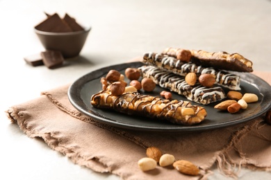 Homemade grain cereal bars with chocolate and nuts on plate