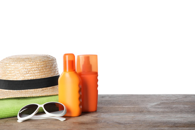 Photo of Sun protection products and beach accessories on wooden table against white background. Space for text