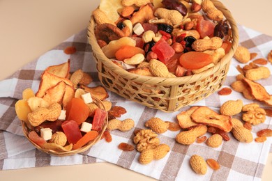 Mixed dried fruits and nuts on beige background