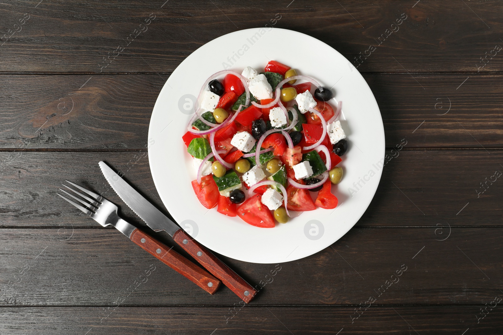 Photo of Plate with delicious salad on table, top view