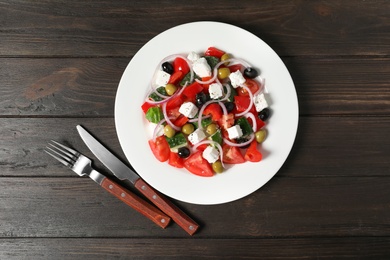 Photo of Plate with delicious salad on table, top view