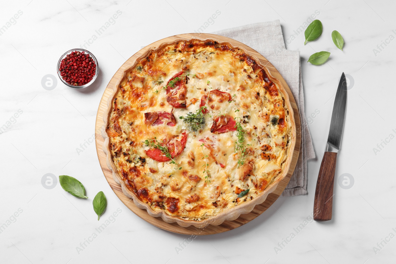 Photo of Tasty quiche with tomatoes, microgreens and cheese served on white table, flat lay