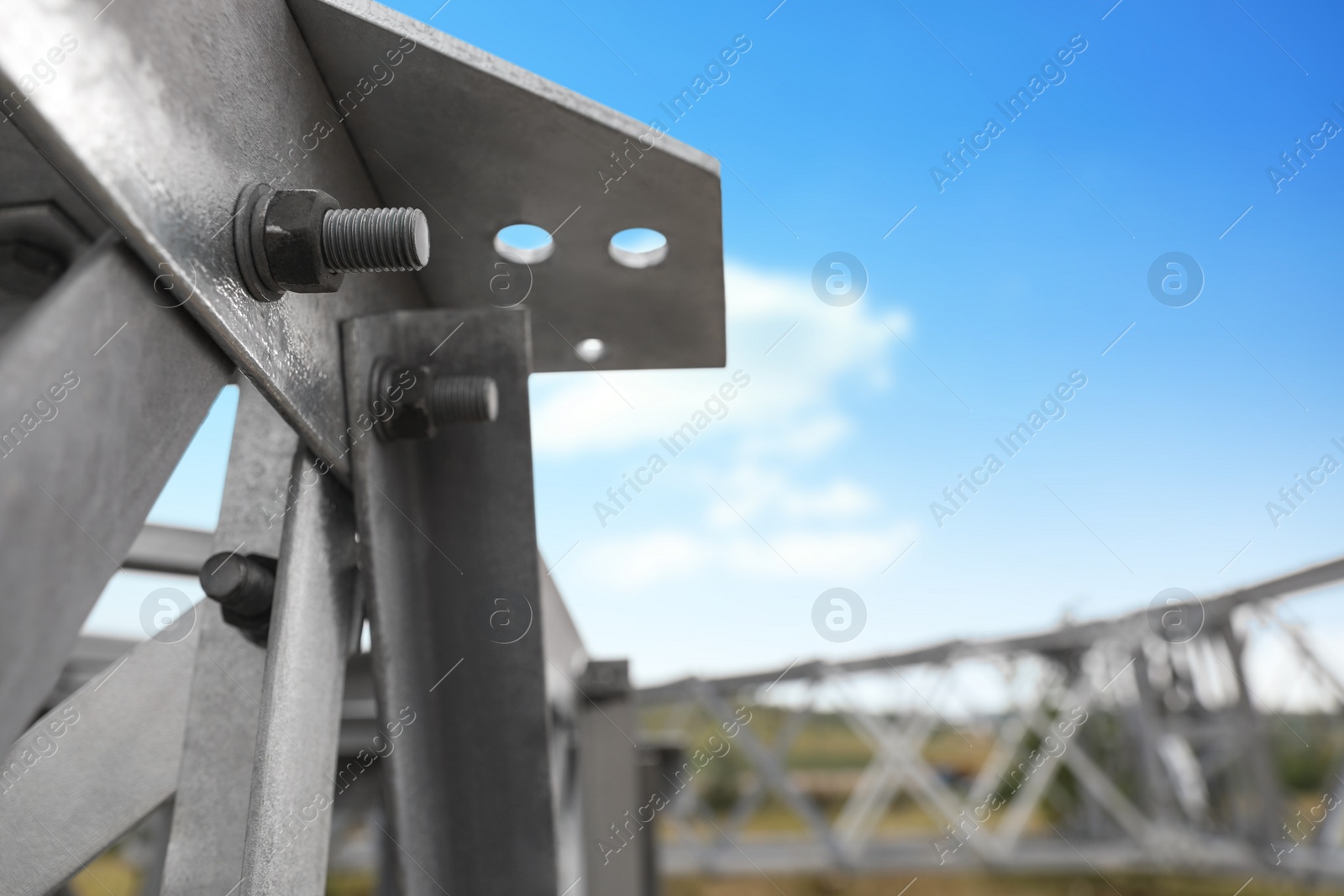 Photo of High voltage tower construction outdoors, closeup. Installation of electrical substation