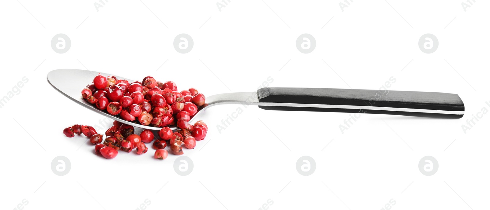 Photo of Spoon of red peppercorns isolated on white