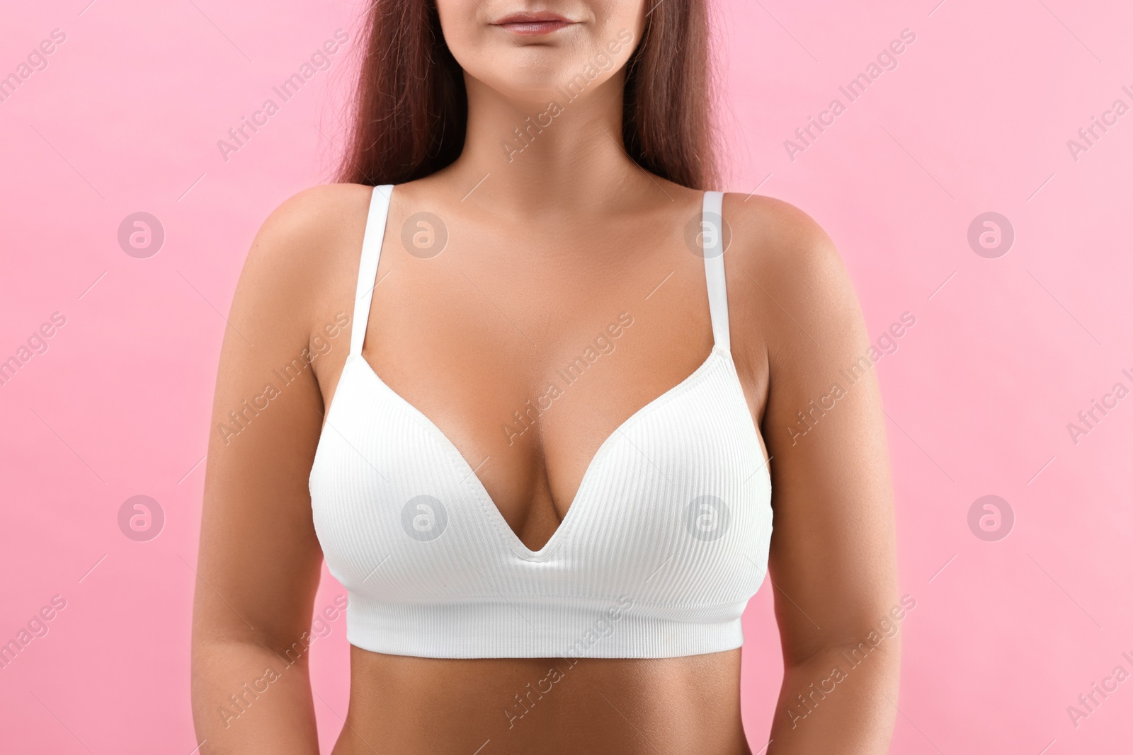 Photo of Woman with beautiful breast on pink background, closeup