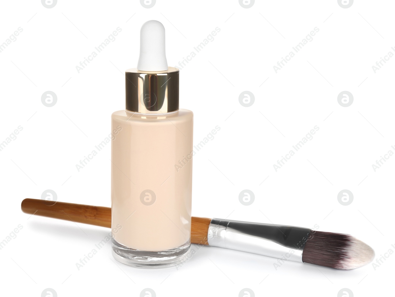 Photo of Bottle of skin foundation and brush isolated on white. Makeup product