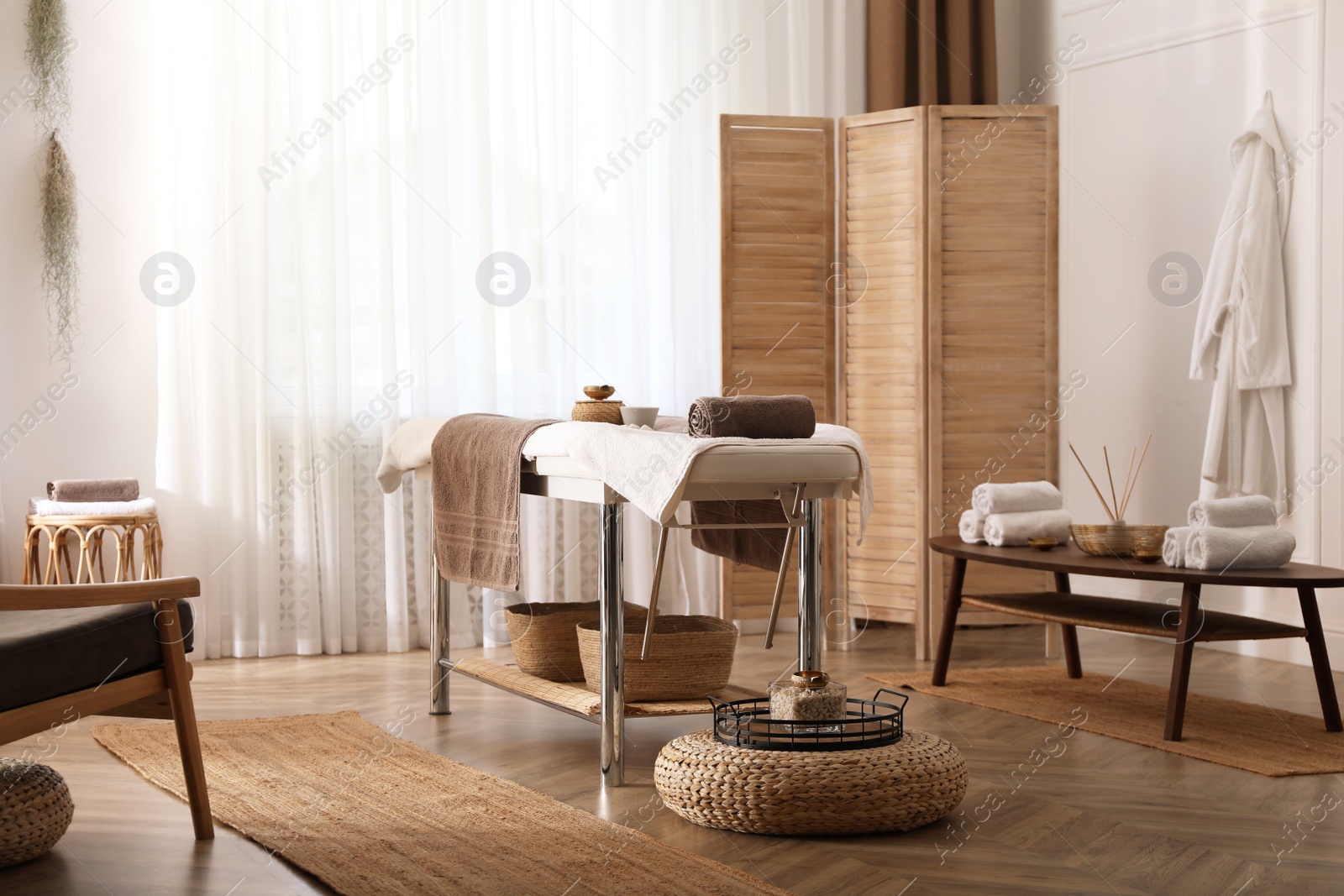 Photo of Stylish room interior with massage table in spa salon