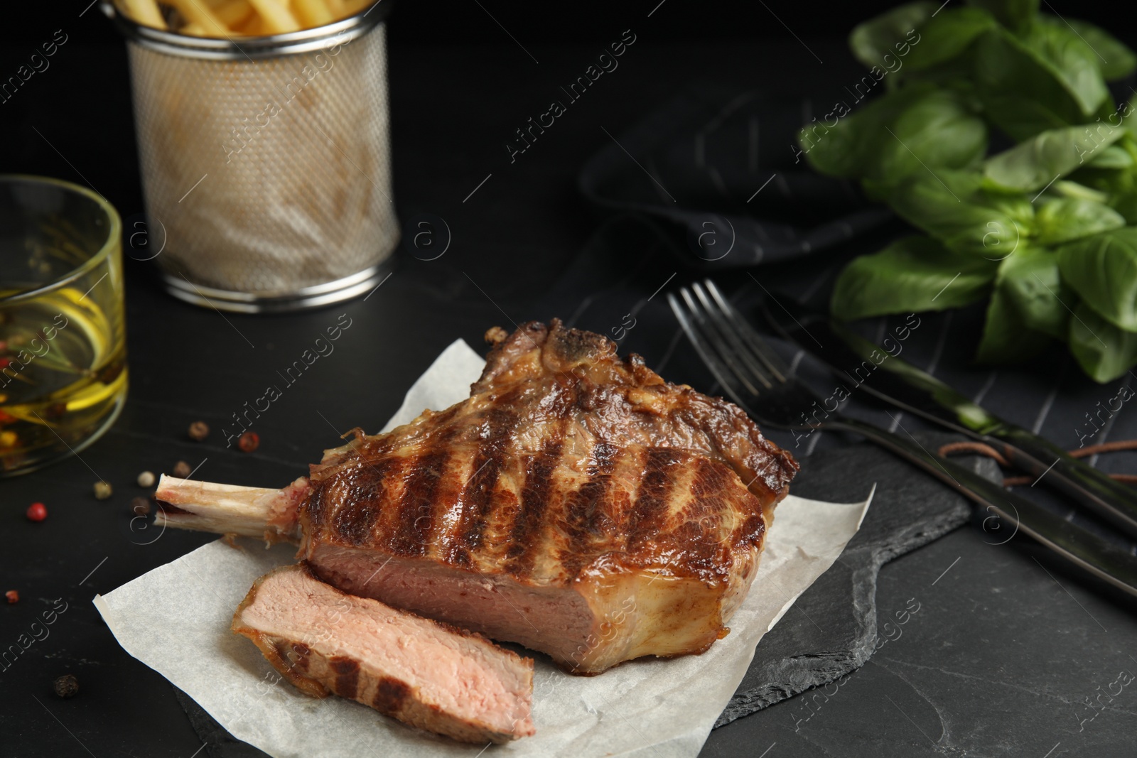 Image of Tasty grilled steak served on black table