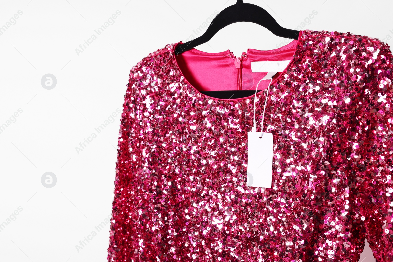 Photo of Beautiful pink women's party dress on hanger, space for text. Stylish trendy clothes for high school prom
