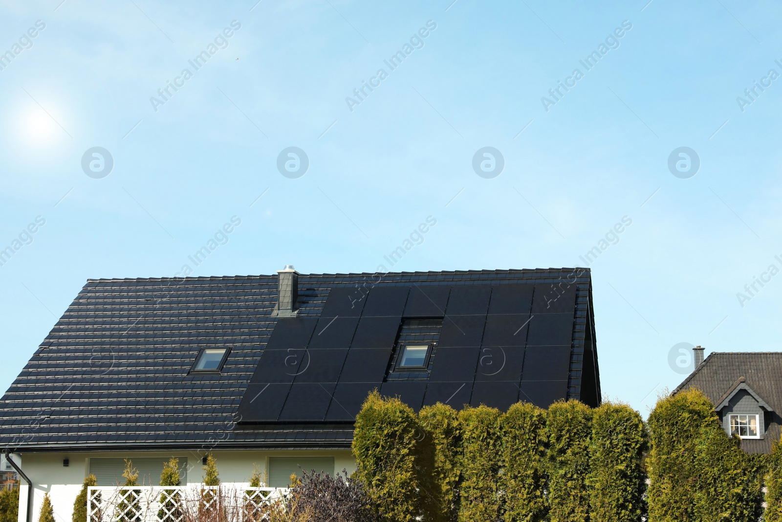 Photo of House with installed solar panels on roof. Alternative energy