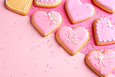 Photo of Composition with decorated heart shaped cookies and space for text on color background, top view. Valentine's day treat