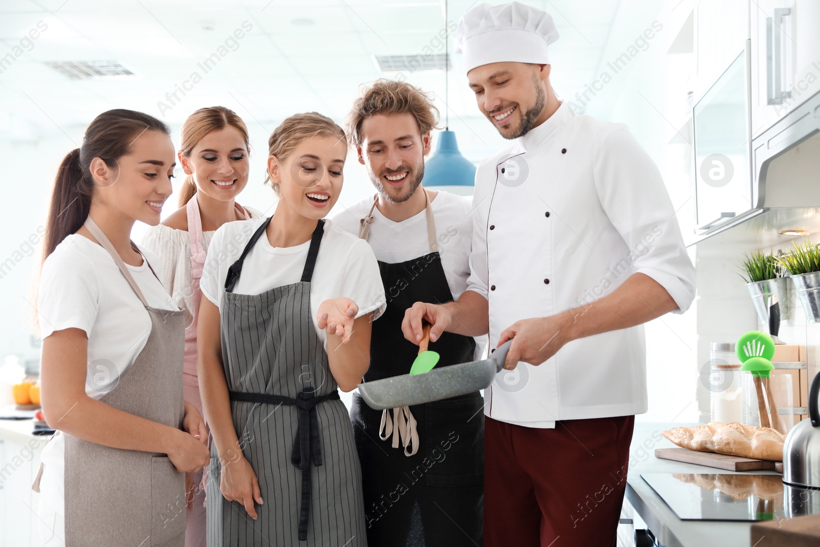 Photo of Group of people and male chef at cooking classes