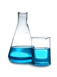 Laboratory glassware with liquid on table against white background. Chemical analysis