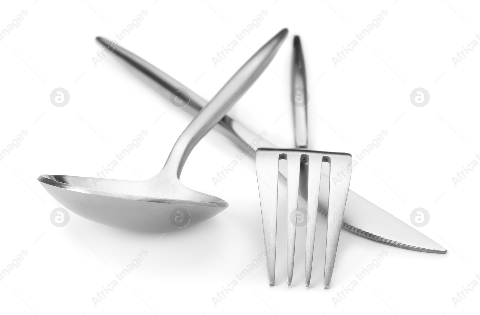 Photo of Shiny silver fork, knife and spoon isolated on white. Luxury cutlery set