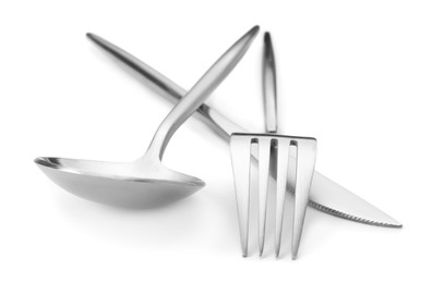 Shiny silver fork, knife and spoon isolated on white. Luxury cutlery set