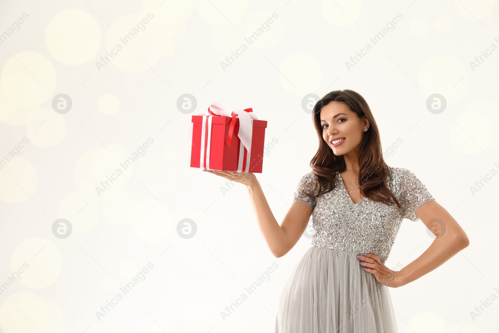 Photo of Beautiful woman with Christmas gift on white background