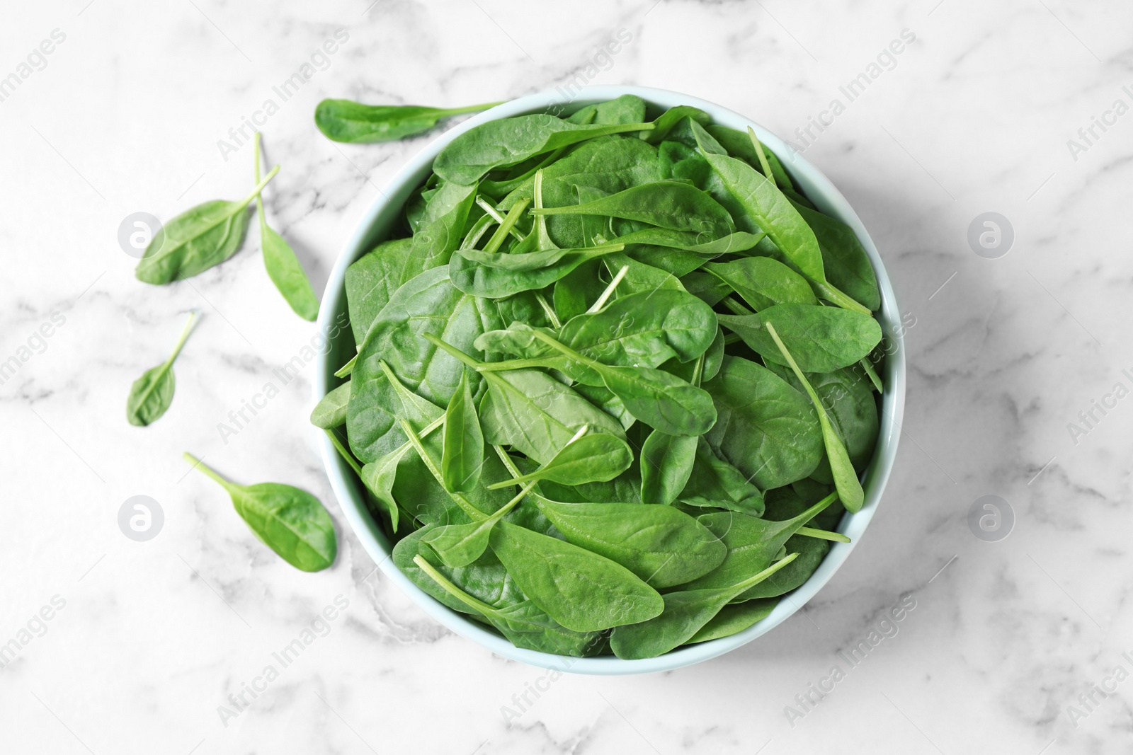 Photo of Fresh green healthy spinach on marble table, flat lay