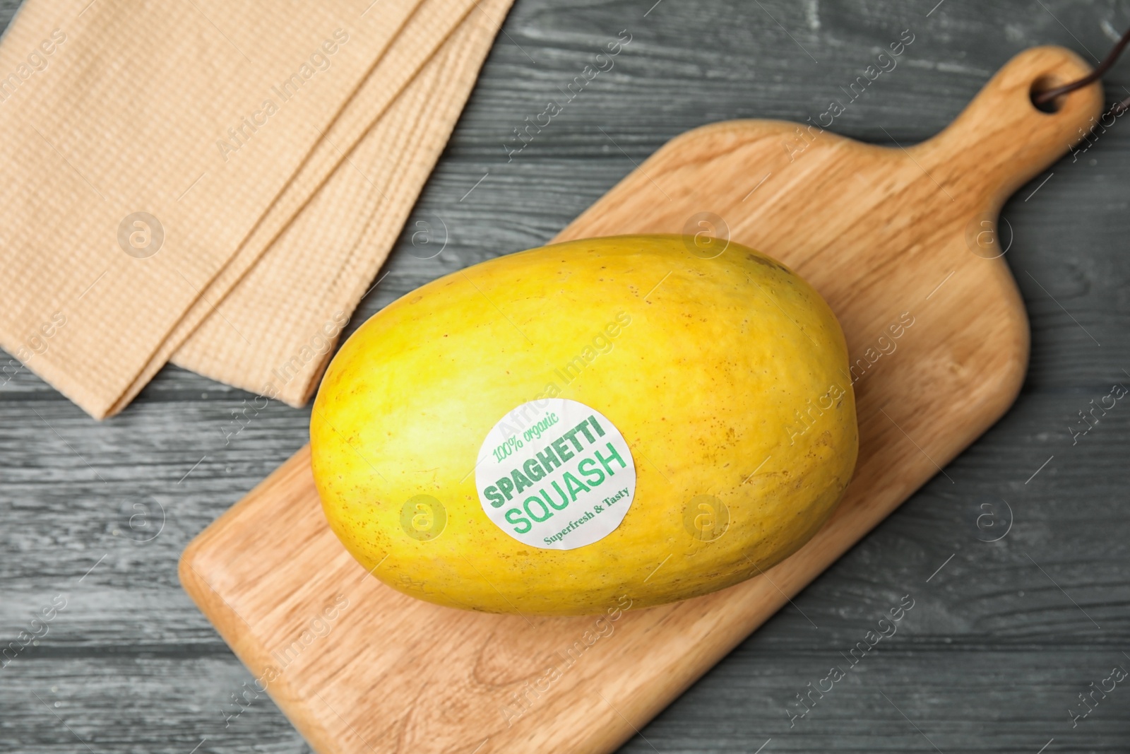 Photo of Whole ripe spaghetti squash on wooden table, top view