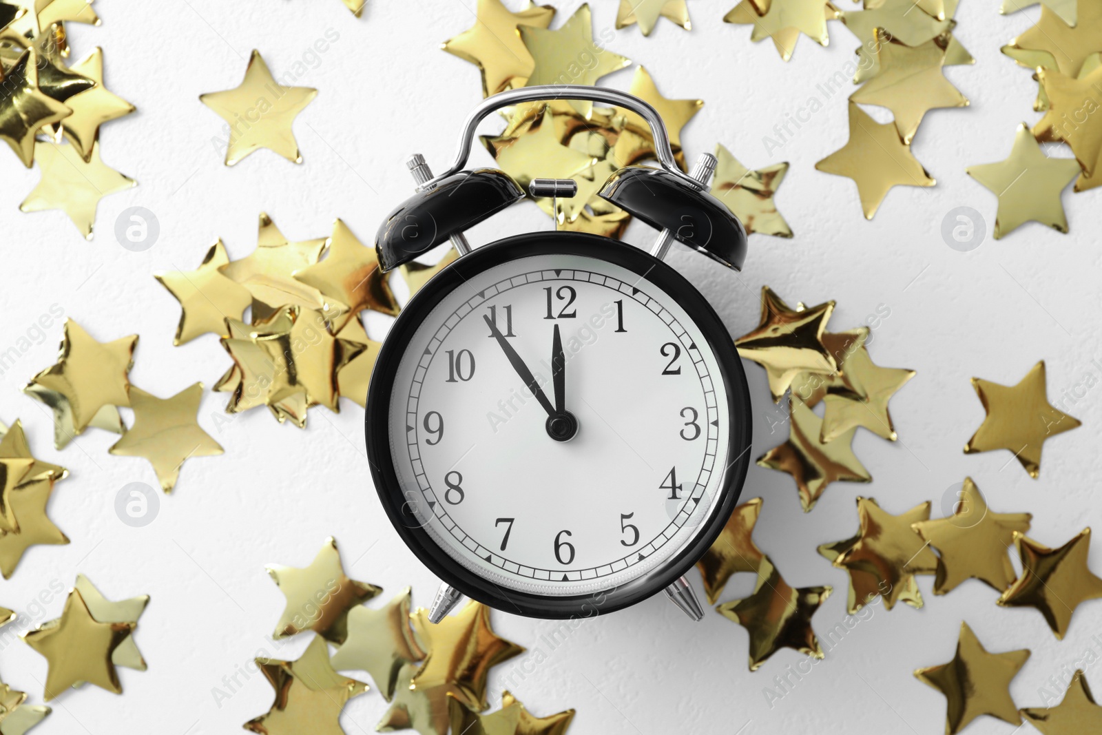 Photo of Alarm clock and Christmas decor on white background, flat lay. New Year countdown