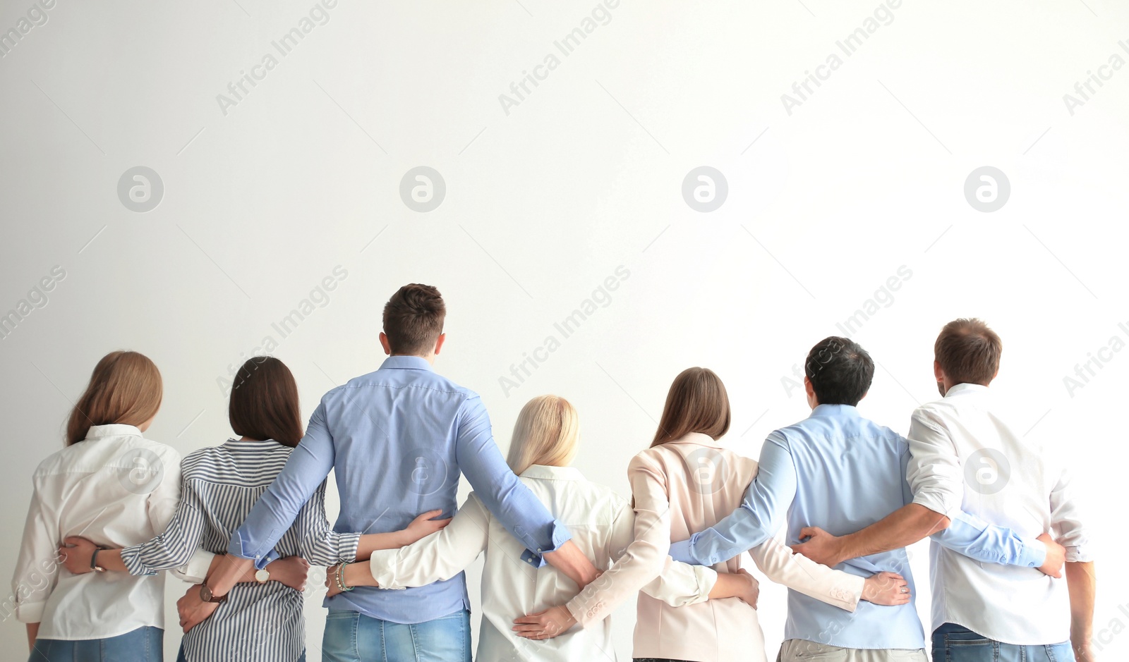Photo of People holding hands on light background. Unity concept