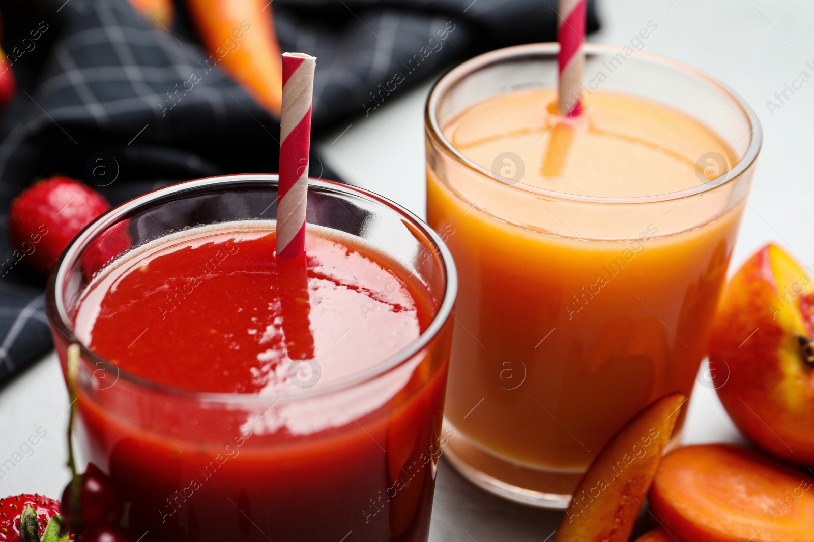 Photo of Delicious juices and fresh ingredients on table, closeup