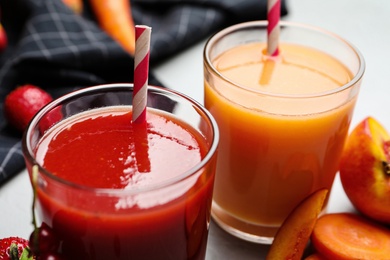 Delicious juices and fresh ingredients on table, closeup