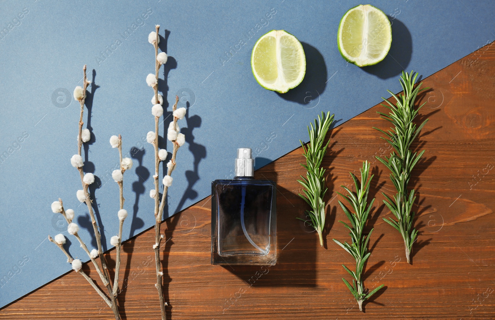 Photo of Beautiful composition with bottle of perfume on wooden table, flat lay