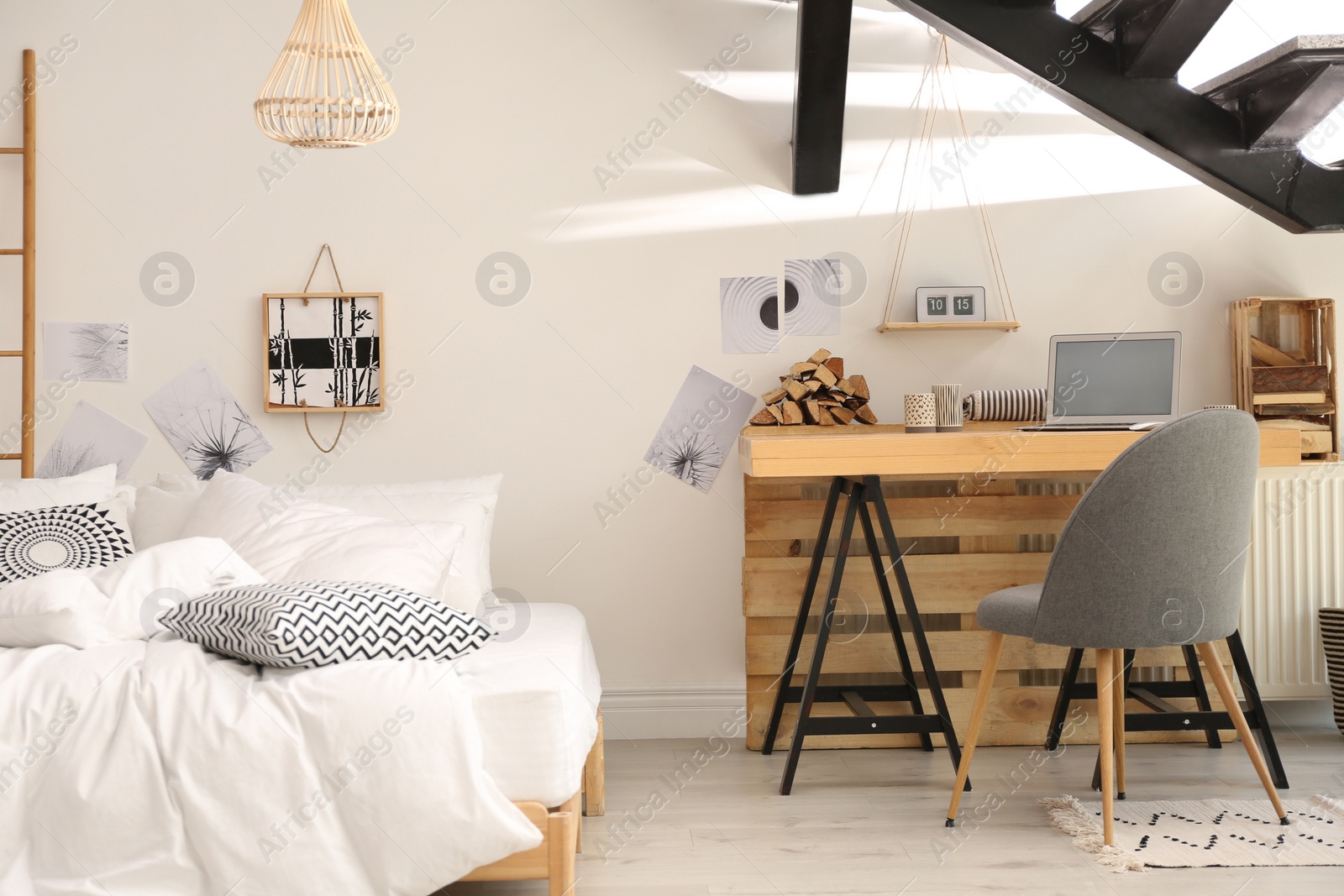 Photo of Elegant interior of bedroom with workplace under stairs