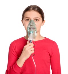 Cute girl using nebulizer for inhalation on white background