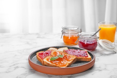 Photo of Toasts with jam on plate