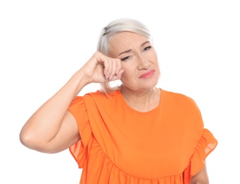 Photo of Mature woman rubbing eye on white background. Annoying itch