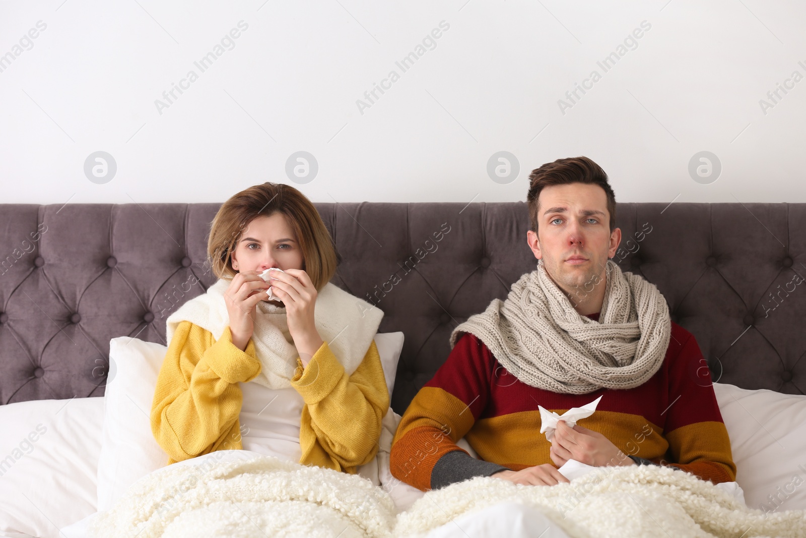 Photo of Couple suffering from cold together in bed