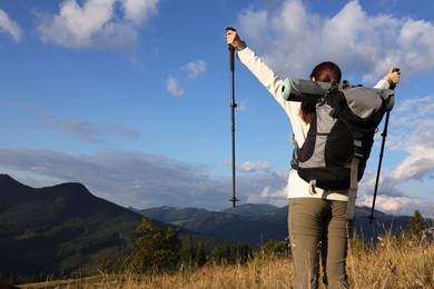 Photo of Triumphant tourist on top of mountain, back view. Space for text