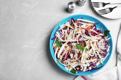 Photo of Flat lay composition with cabbage salad on light grey marble table. Space for text