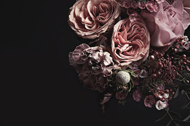 Photo of Beautiful bouquet on black background, closeup. Floral card design with dark vintage effect