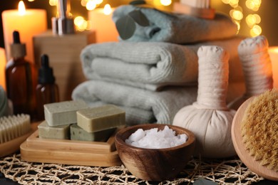 Beautiful composition with different spa products on table against blurred lights