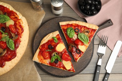 Photo of Slices of delicious pita pizza on wooden table, flat lay