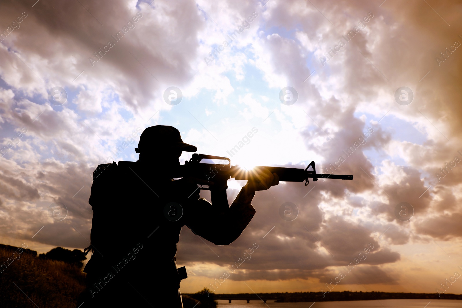 Photo of Soldier with machine gun patrolling outdoors. Military service