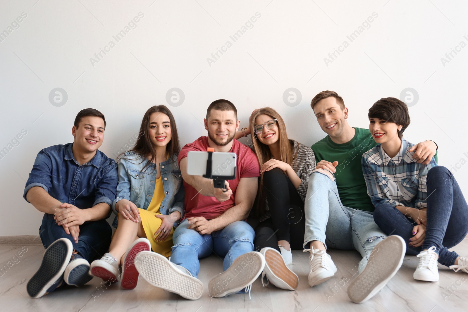 Photo of Happy friends taking selfie indoors