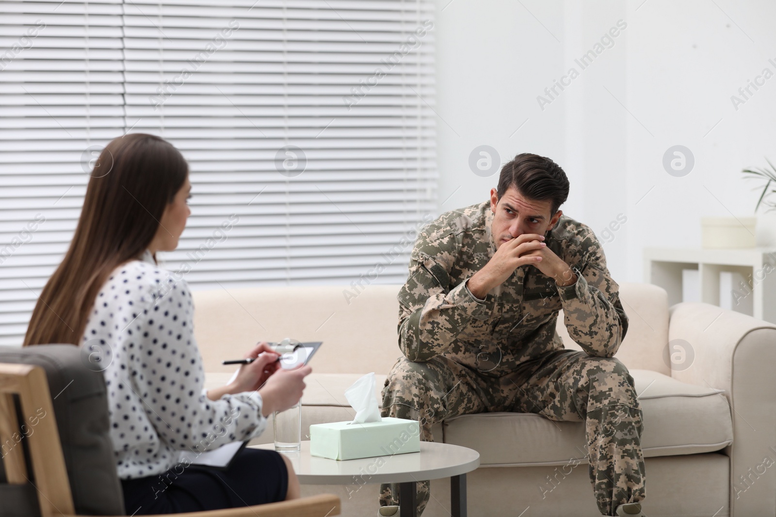 Photo of Psychotherapist working with male military officer in office