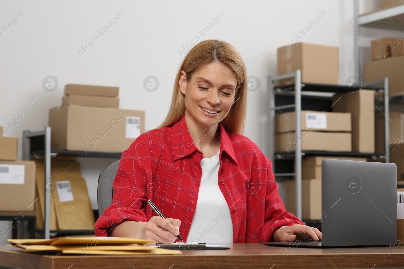 Photo of Seller with laptop working in office. Online store