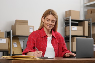 Photo of Seller with laptop working in office. Online store